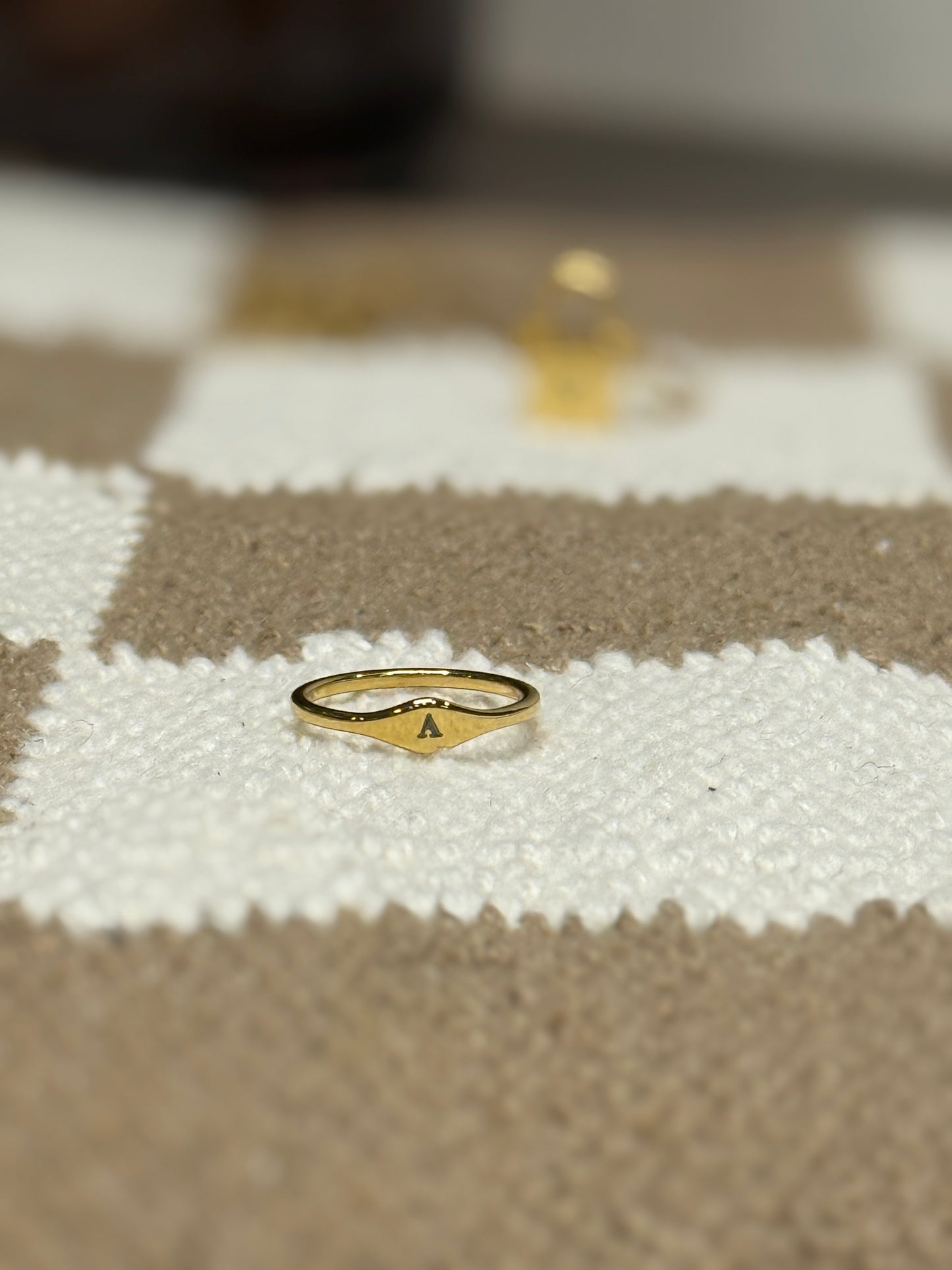Dainty engraved initial ring on hand