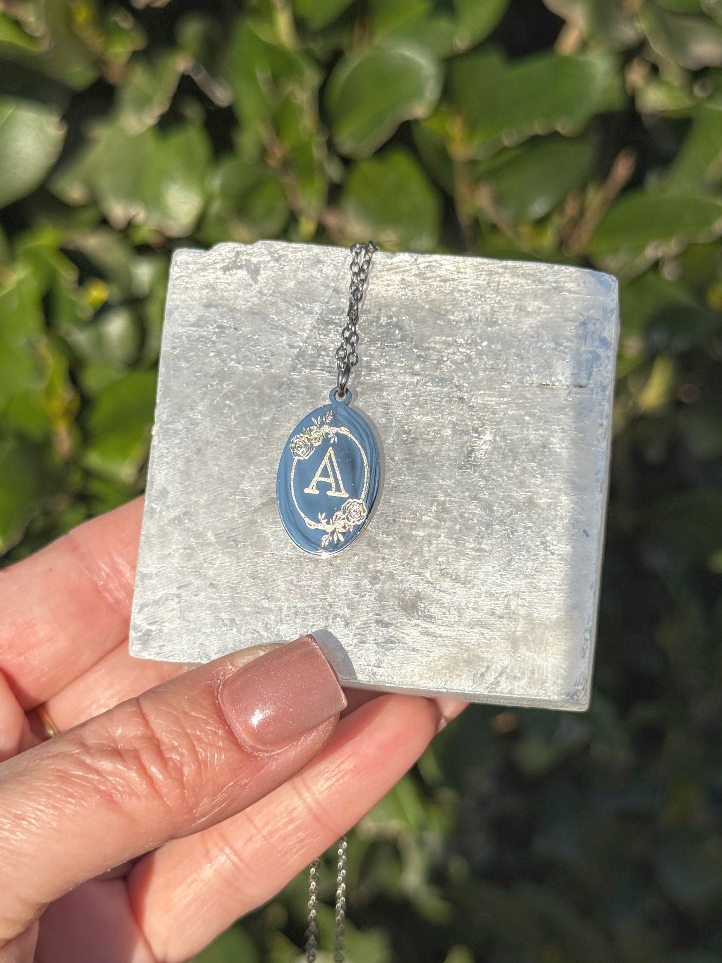 Oval charm necklace on neck — lifestyle photo