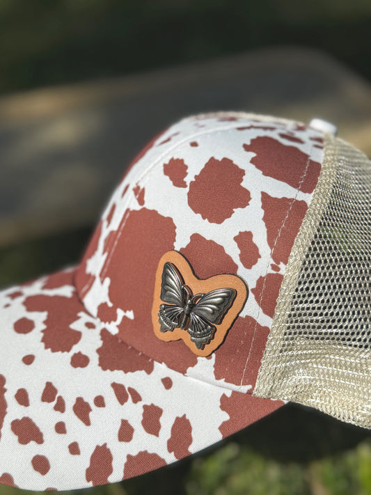 Butterfly on Cow Print Trucker